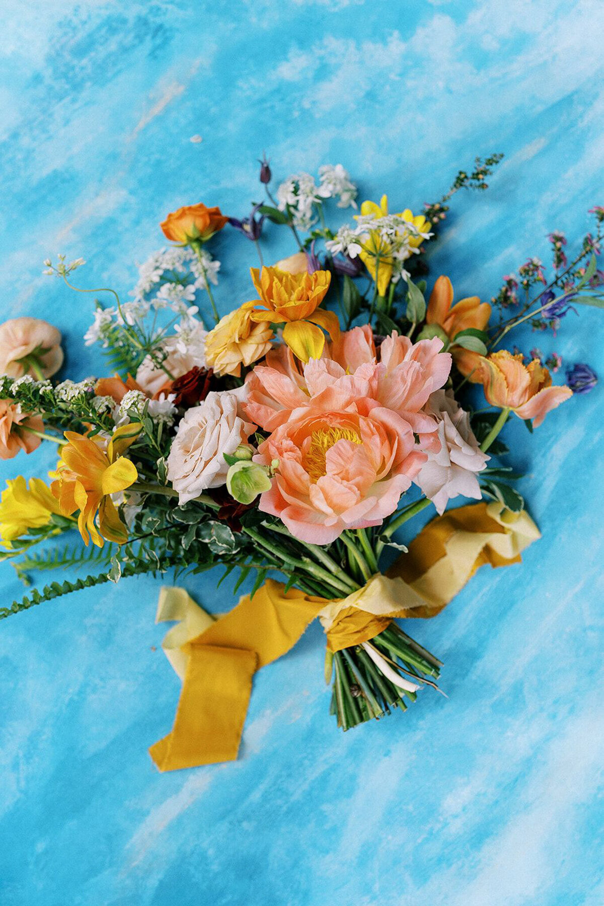 Bright and colourful spring inspired bridal bouquet by Hue Florals, artistic Calgary, Alberta wedding florist, featured on the Brontë Bride Vendor Guide.