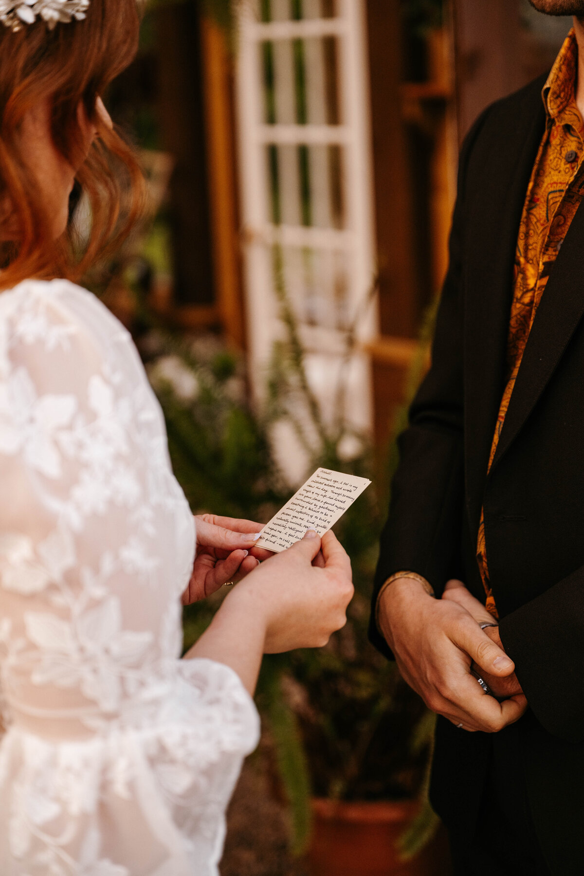 Bride reads her hand written vows during their elopement at The Greenhouse on Strawberry Lane | Nova Scotia