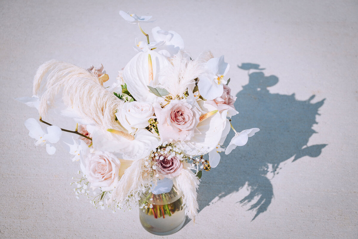 bridal bouquet with orchids, blush roses, bleached pampas, and anthuriums