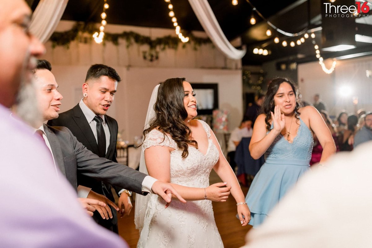 Bride dances with her guests at the reception
