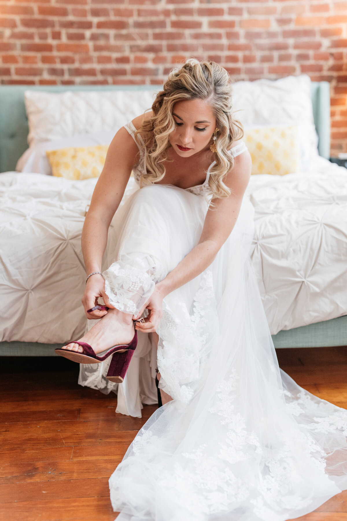 bride putting on shoes on wedding day