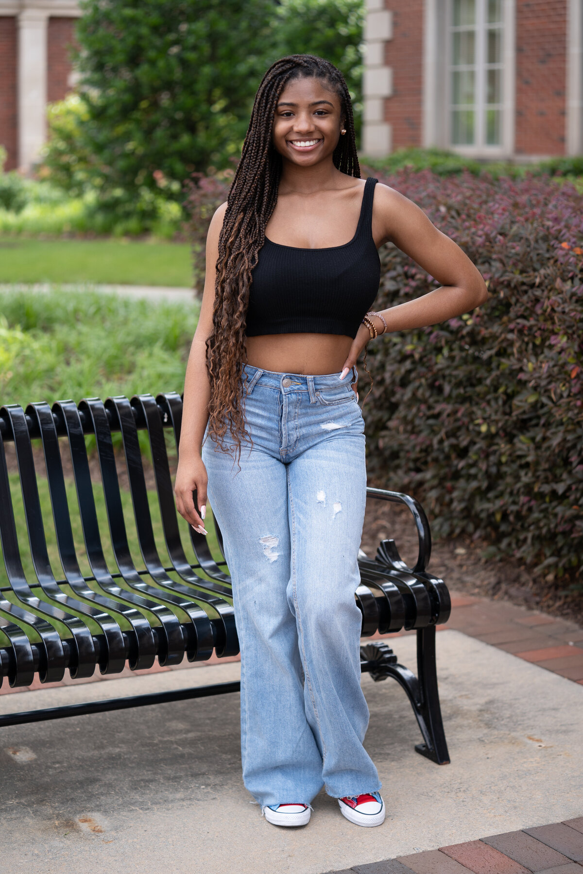 Black female black top blue jeans