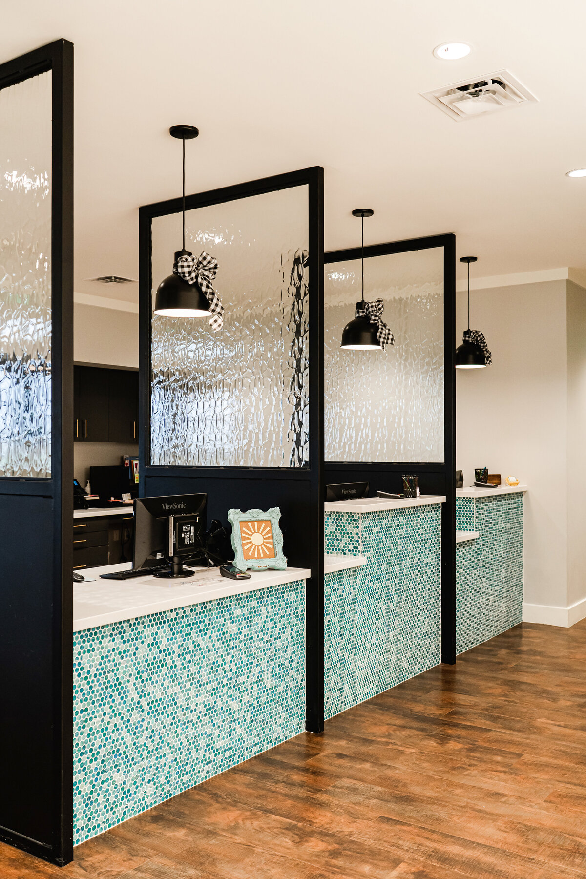pediatric dentistry reception desk with mosaic tile front and glass divider walls