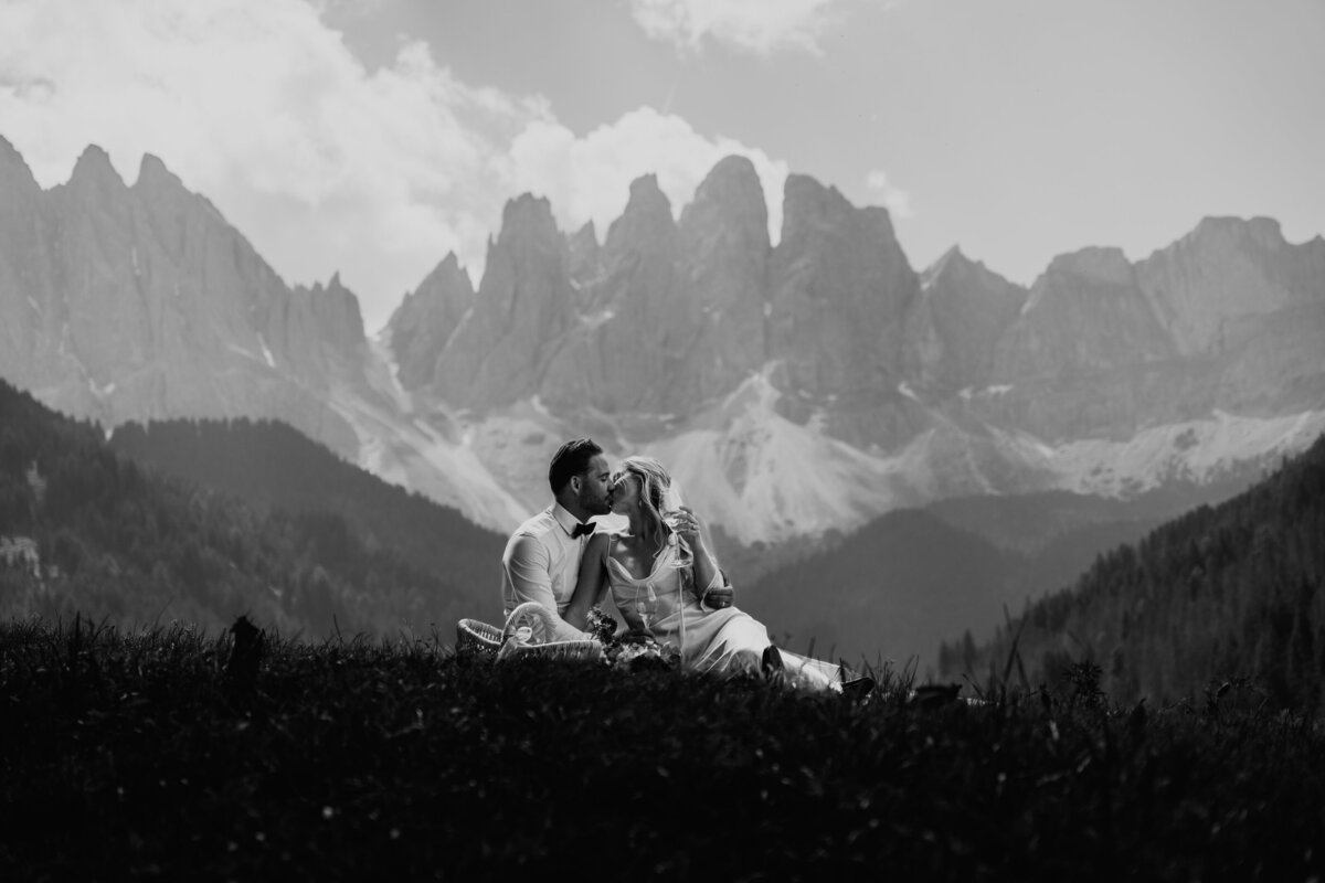 Scenic view of Dolomites peaks behind bride and groom