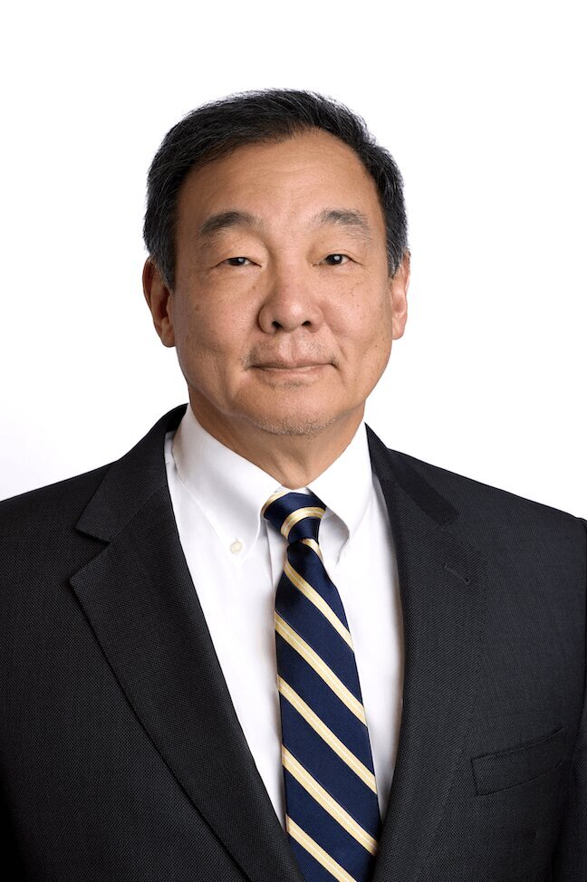 Lawyer Headshot of a man in a suit smiling at the camera