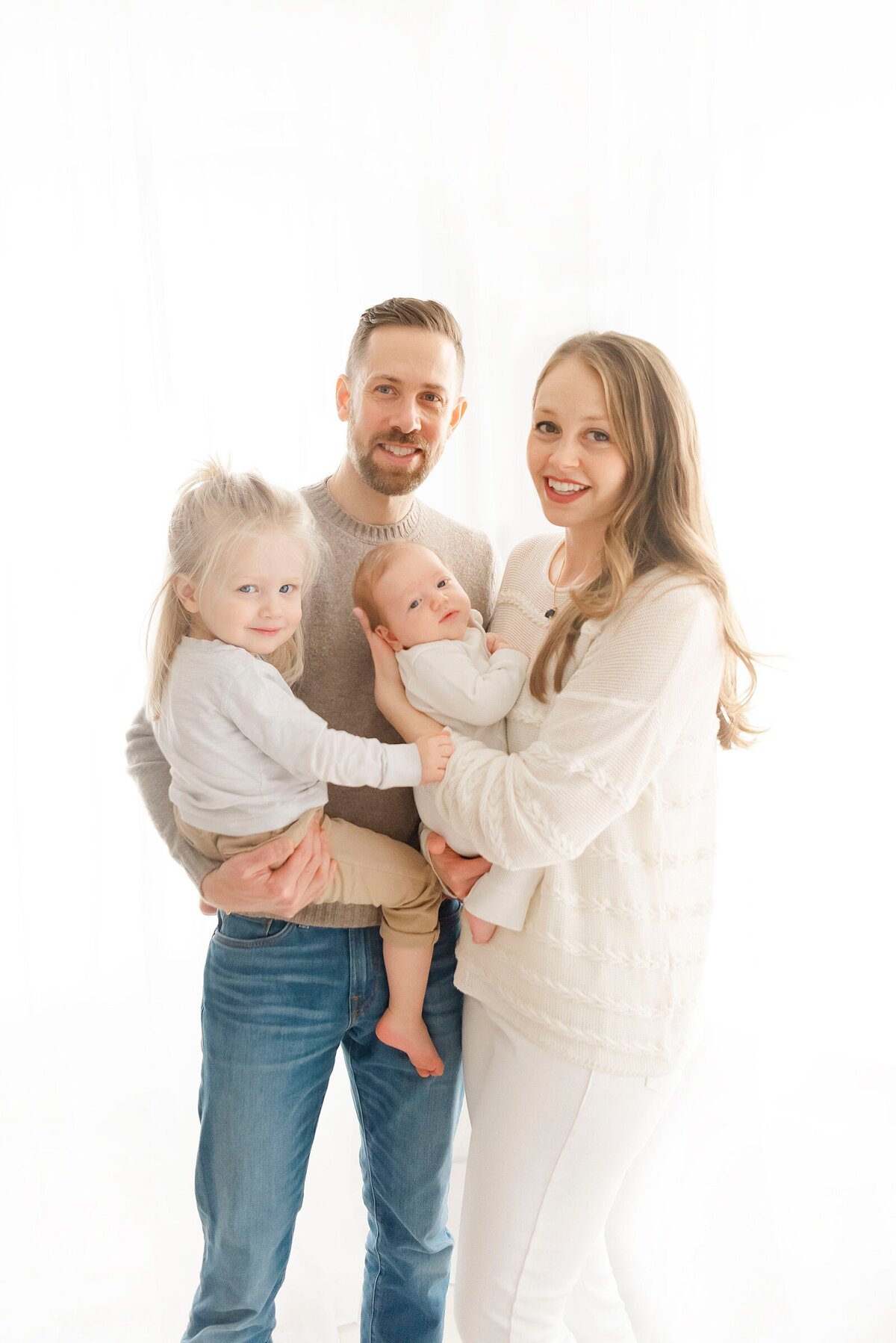 family smiling by best boston family photographer​