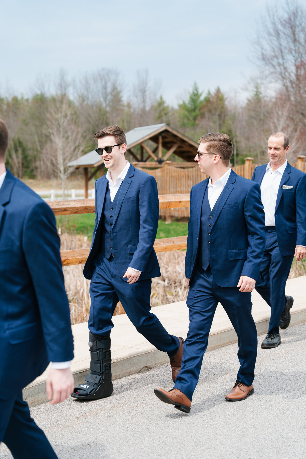 Candid moment of the groom adjusting his tie before the ceremony