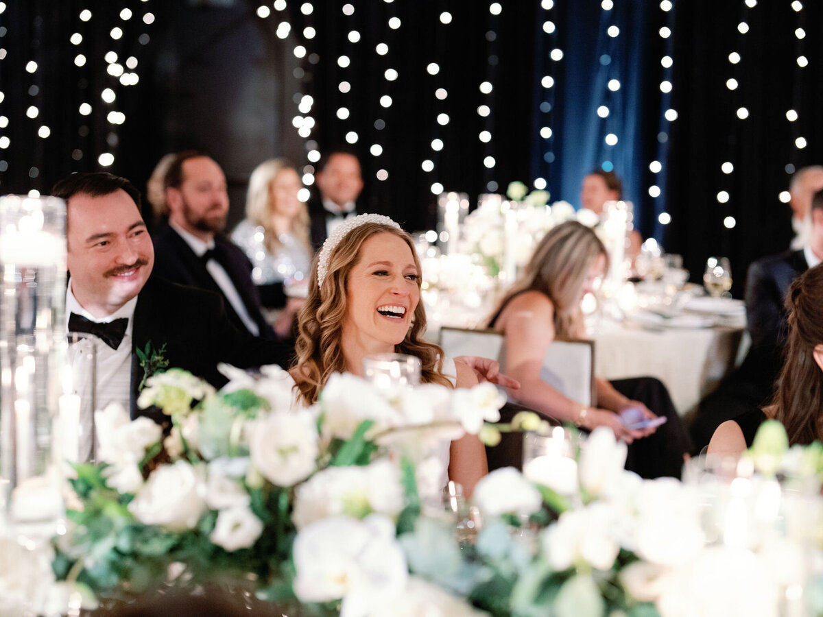 Bride and Groom sitting at the table at the wedding reception. 
