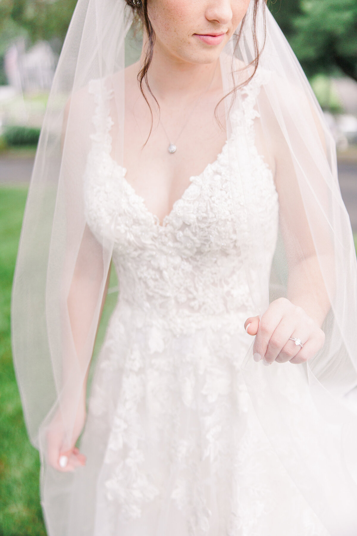 Close up of bride adjusting her veil representing romantic Boston bridal pictures