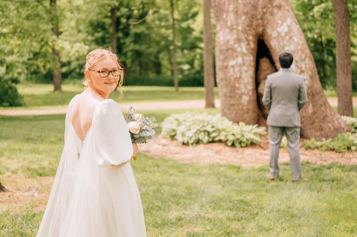 Bride and groom having their first look in front of sycamore tree