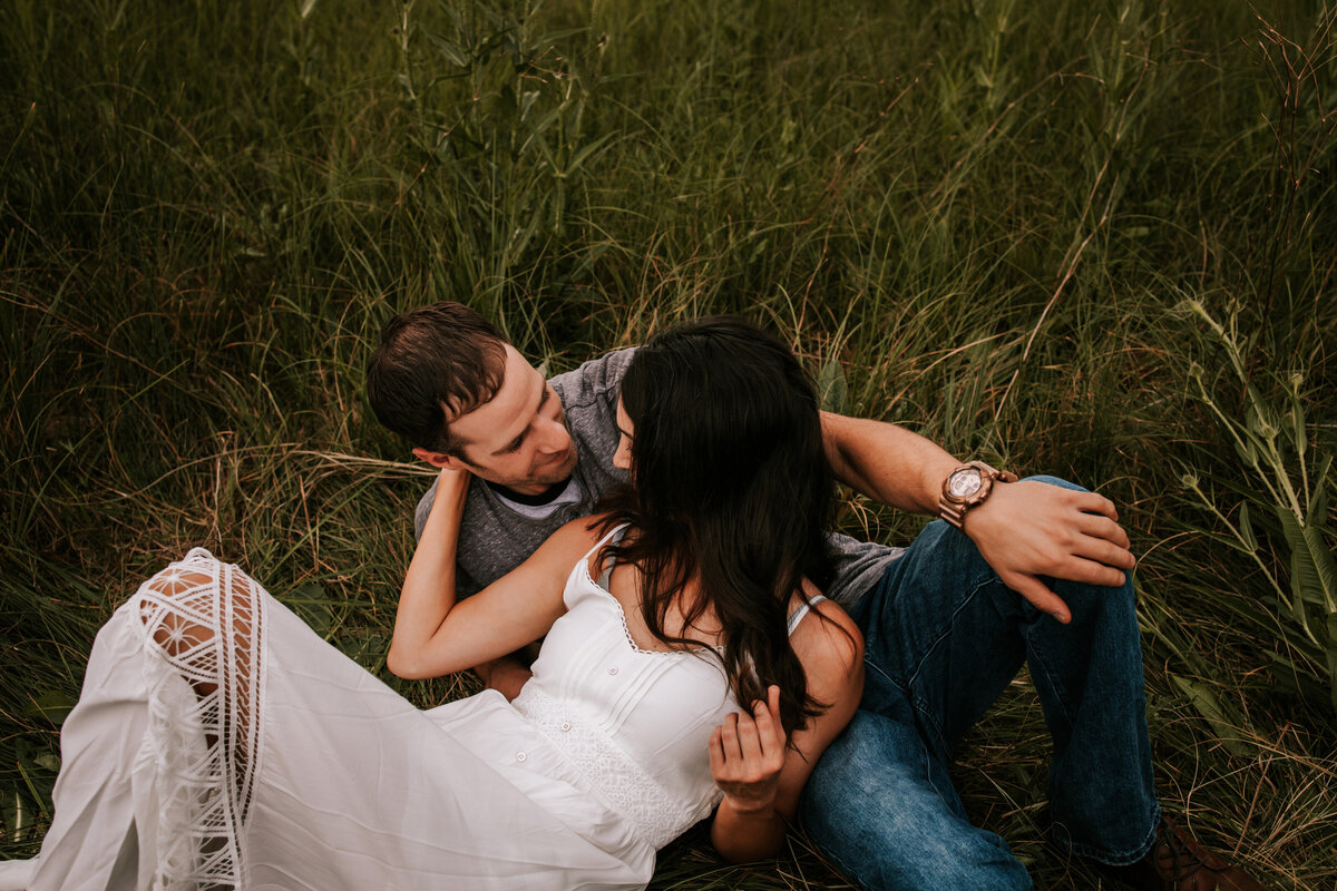 colorado couple embrace in wheat field in thornton colorado for engagement photos