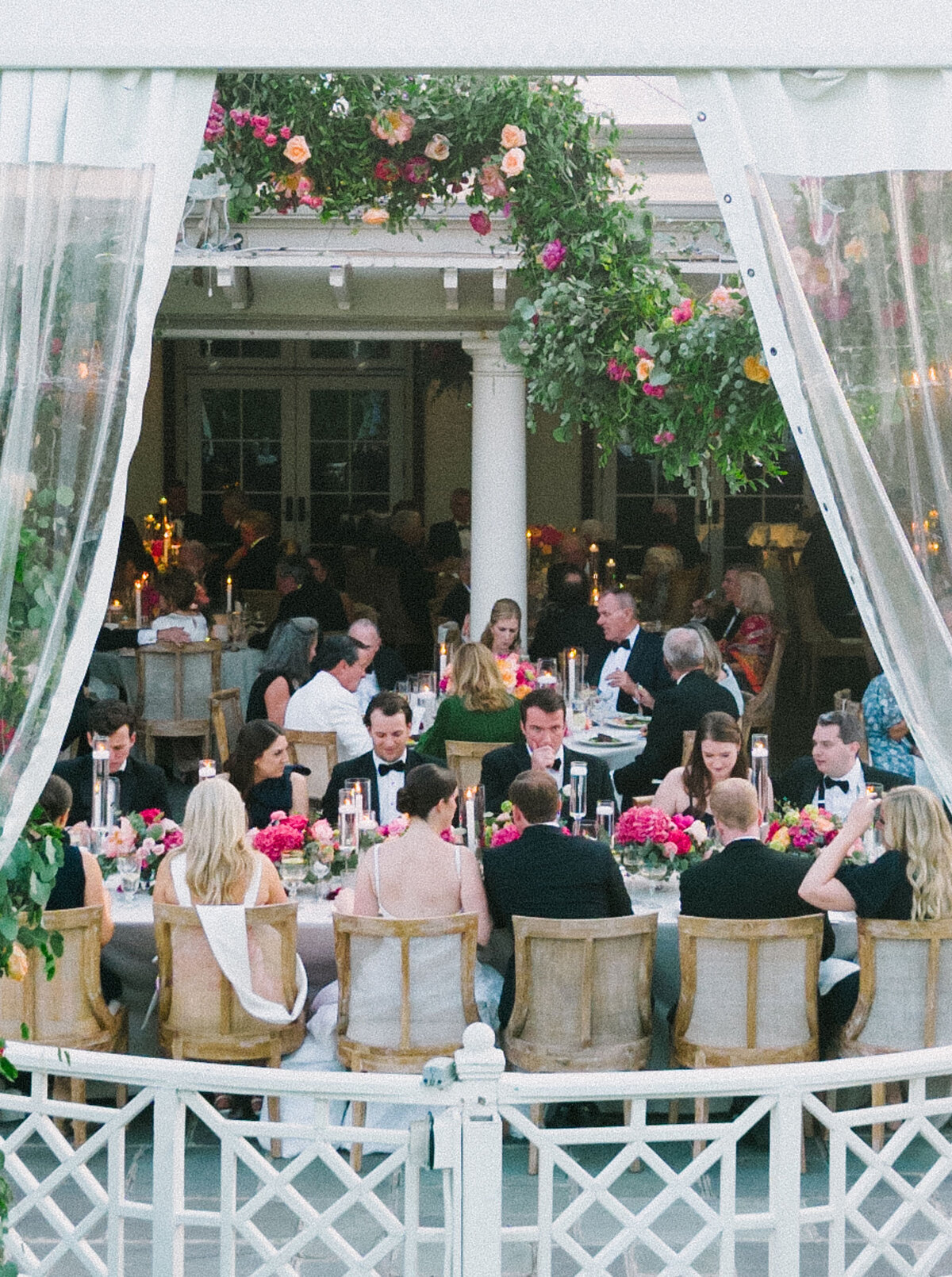 Wedding party enjoying the reception under the canopy. 