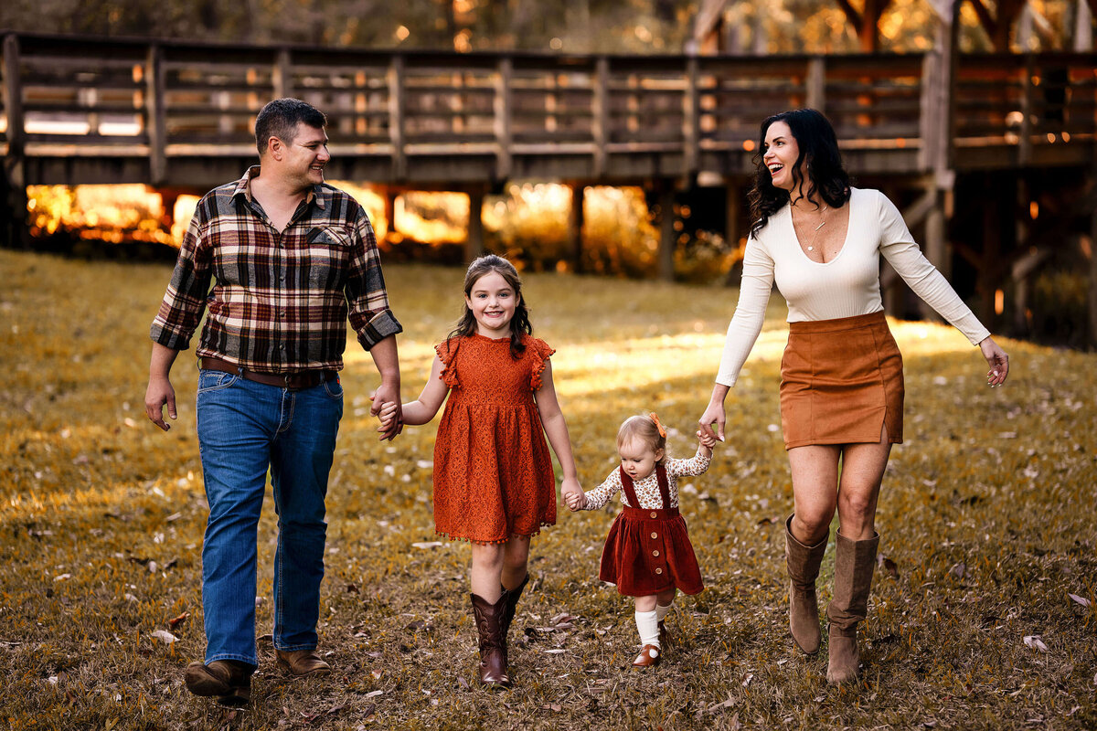 Family walking together laughing in front of the covered bridge in Silverhill,  Alabama