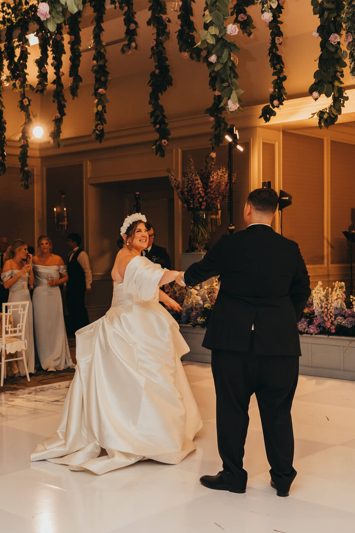 bride and groom share a first dance among their guests.