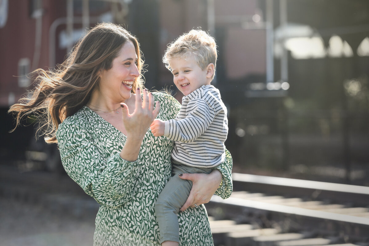 A mother smiling and holding her child