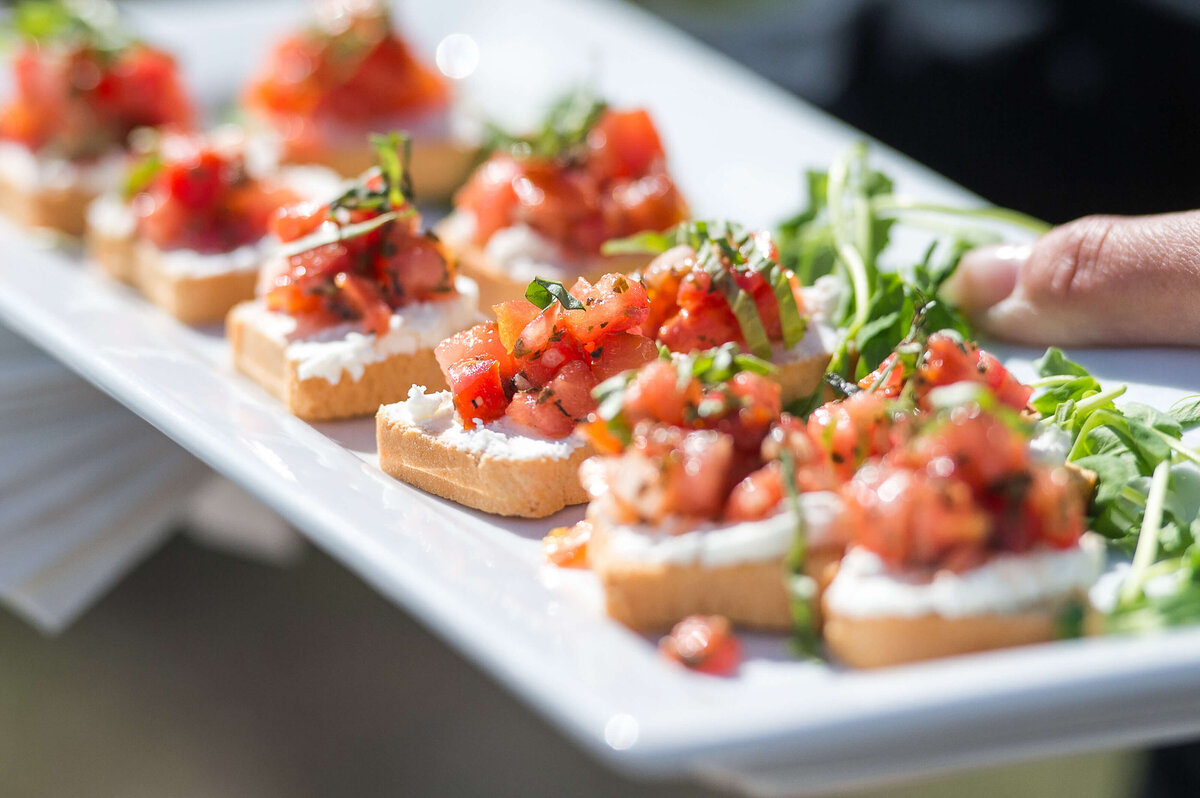 a tray of bruschetta being served to guests at a corporate anniversary celebration.  Captured by Ottawa Event Photographer JEMMAN Photography COMMERCIAL