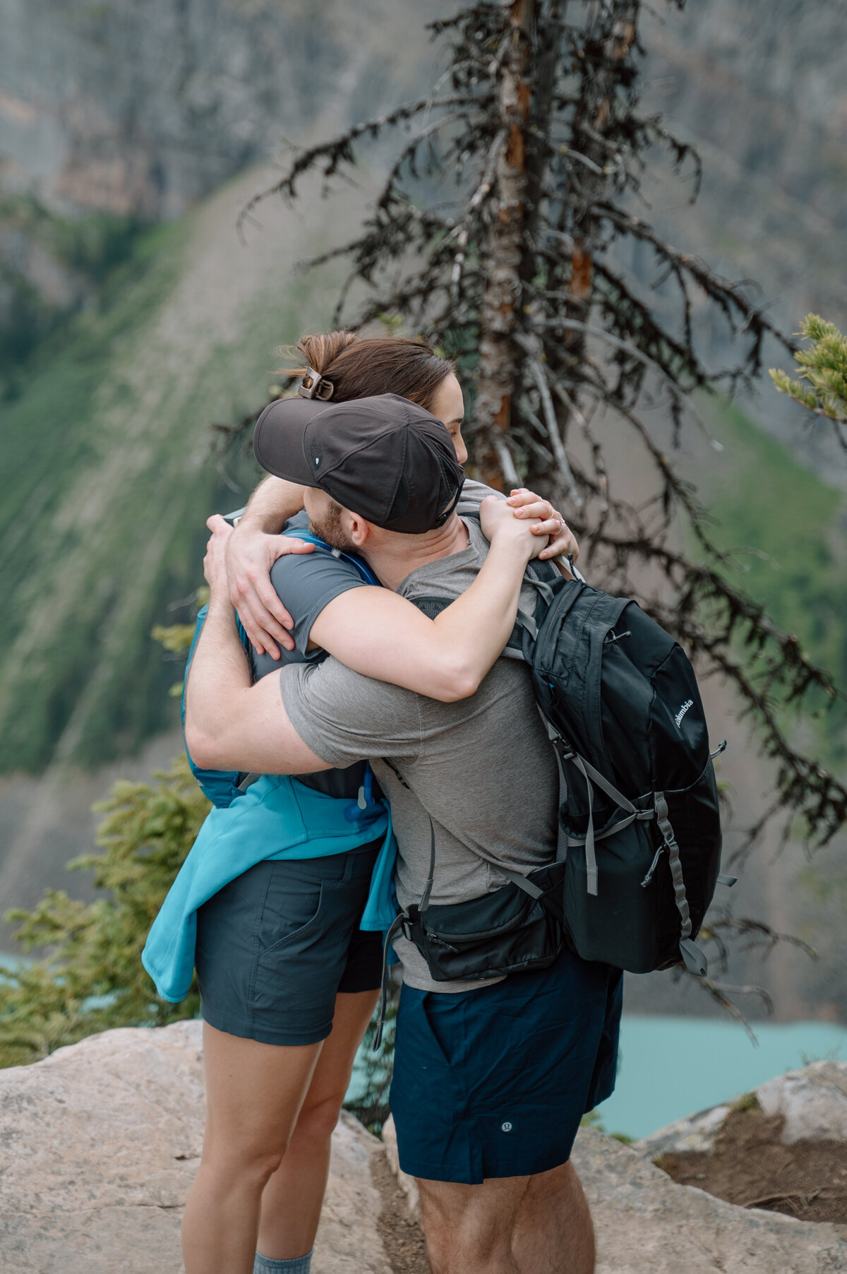 Emotional hug after engagement at big beehive, captured during a stunning mountain hiking proposal session.