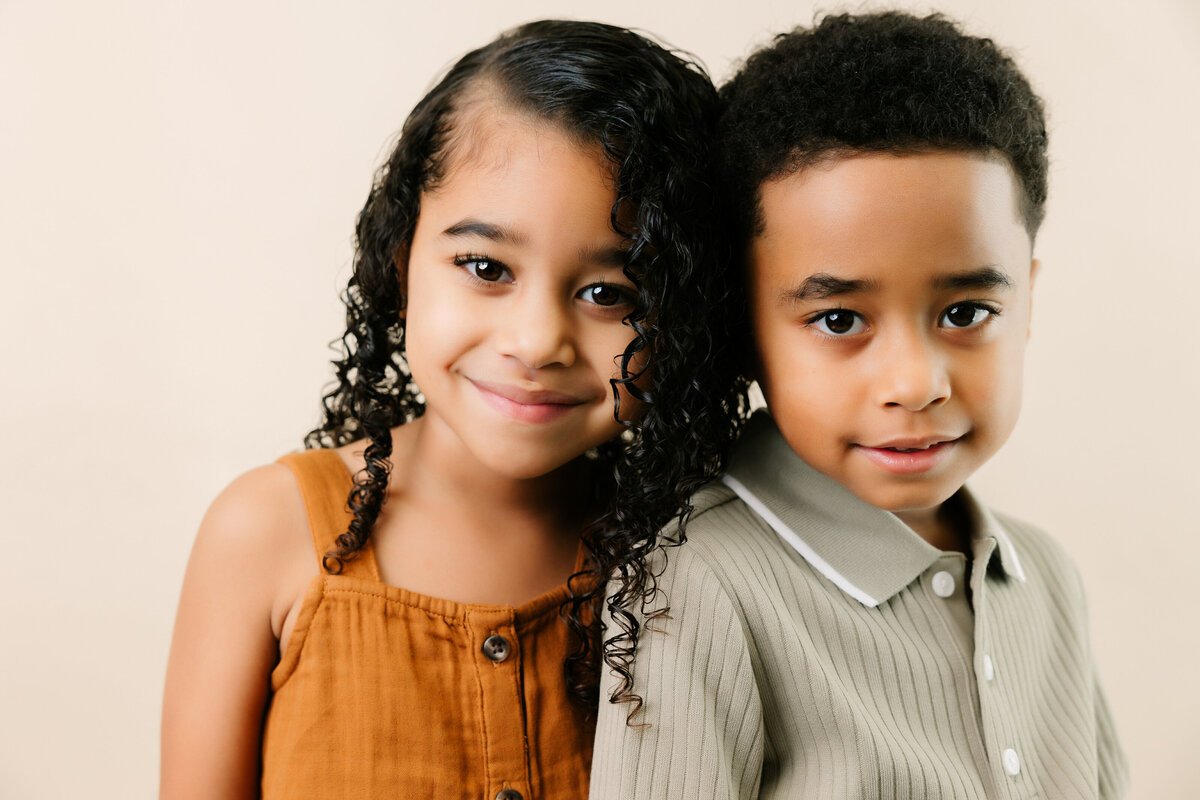 Close up portrait of brother and sister smiling at the camera