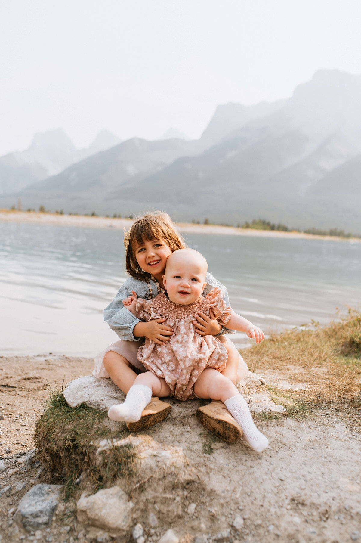 Little-girl-holding-baby-in-Canmore