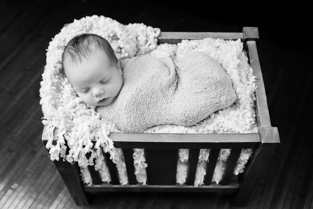 Newborn baby sleeping in black and white portrait