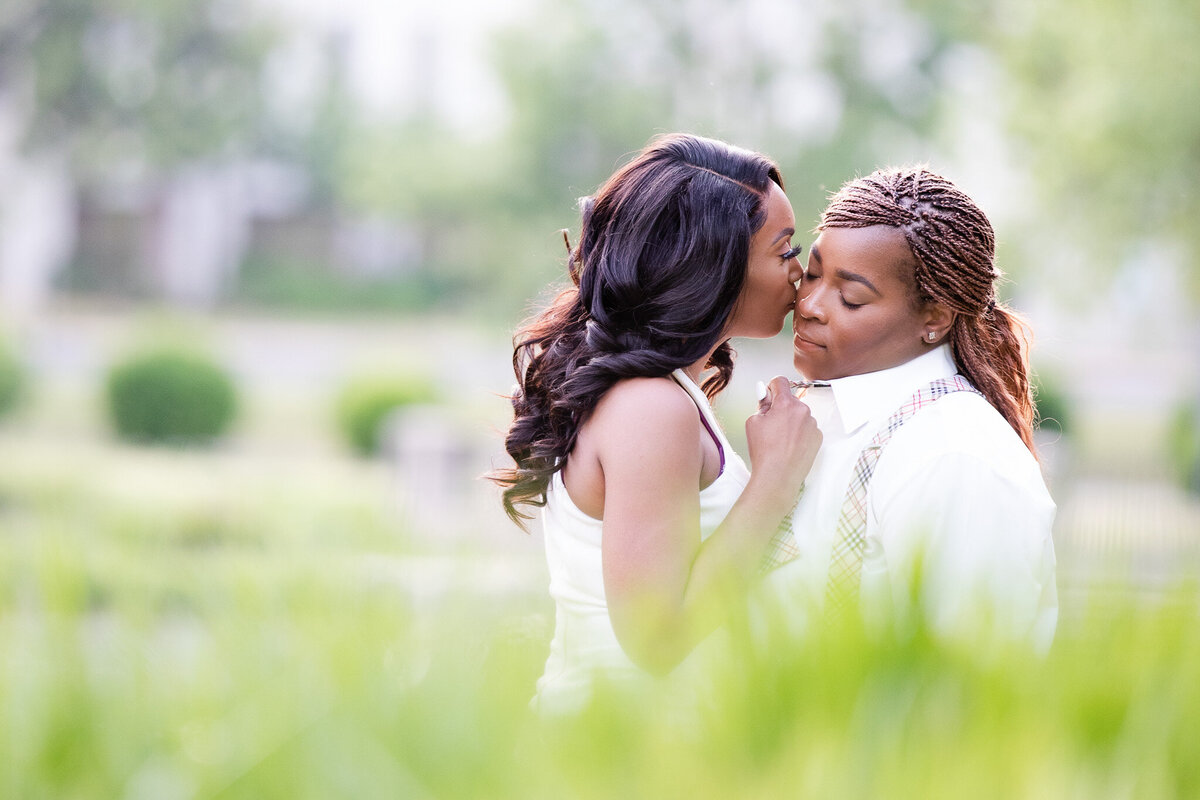 Two queer women embrace during their engagement session