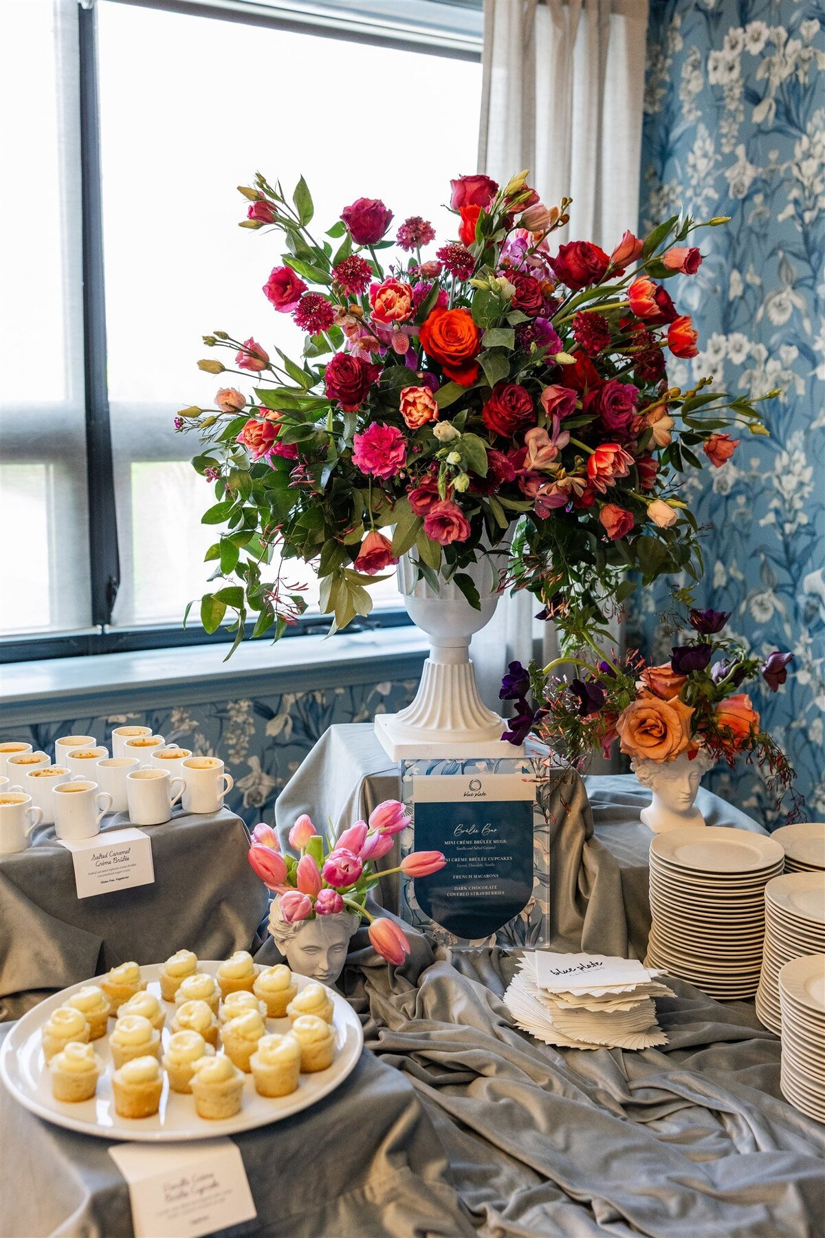 Bridal suite repurposed as a sweets station, with elegant displays of desserts on vintage furniture, soft lighting, and bridal-themed decor creating a charming and whimsical atmosphere