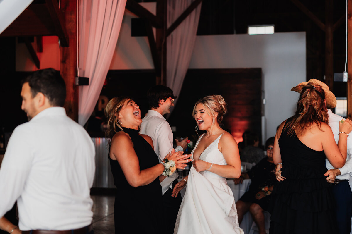 A mom dances with her daughter at a wedding.