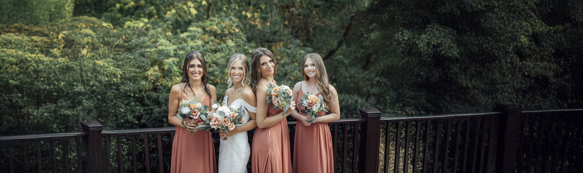 The English Manor | Bride and bridesmaids smiling during summer wedding photo | Ocean Township, New Jersey