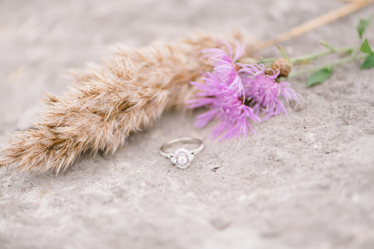 Close up of ring on a rock with flower details
