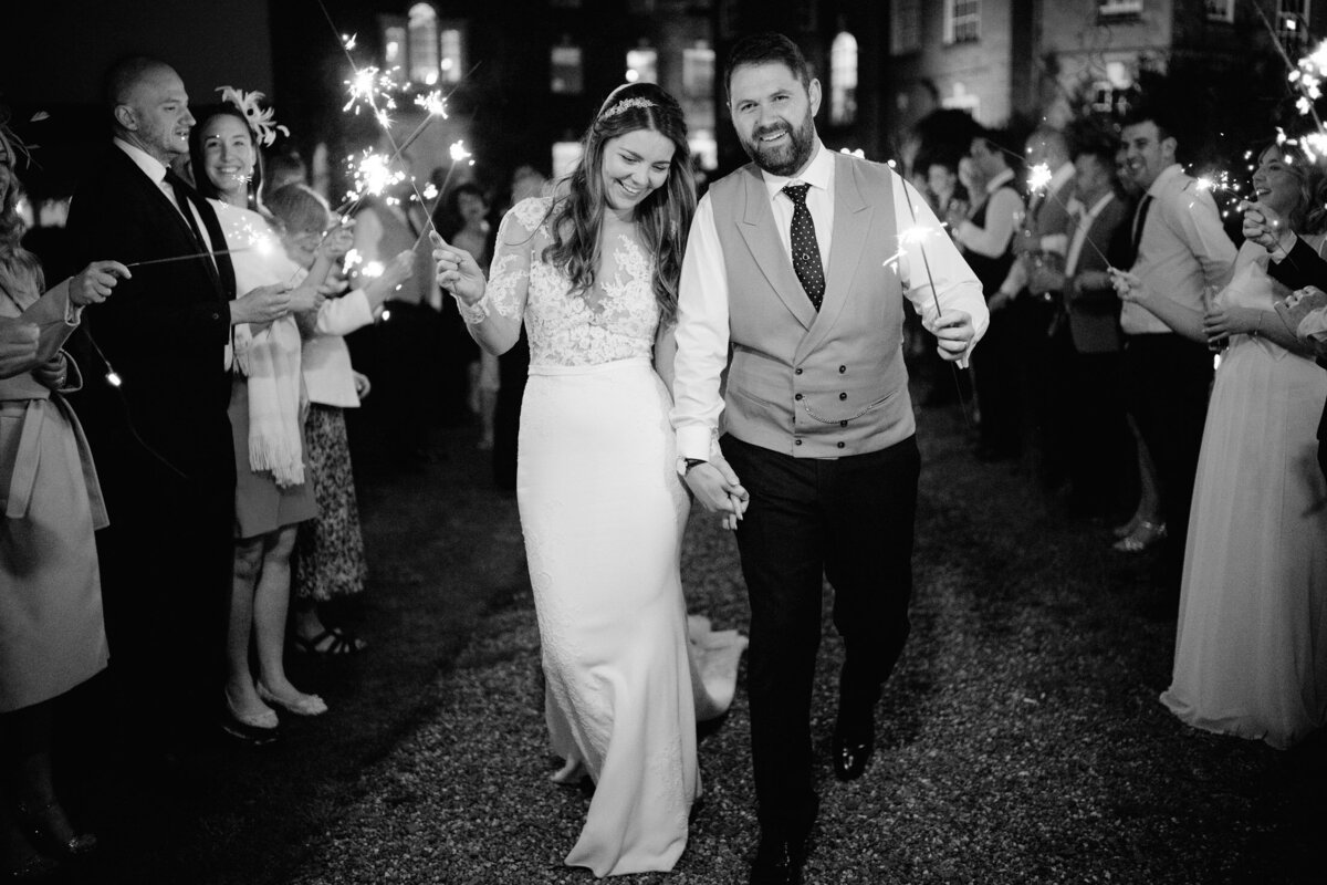The bride and groom walk-through sparklers after their wedding reception