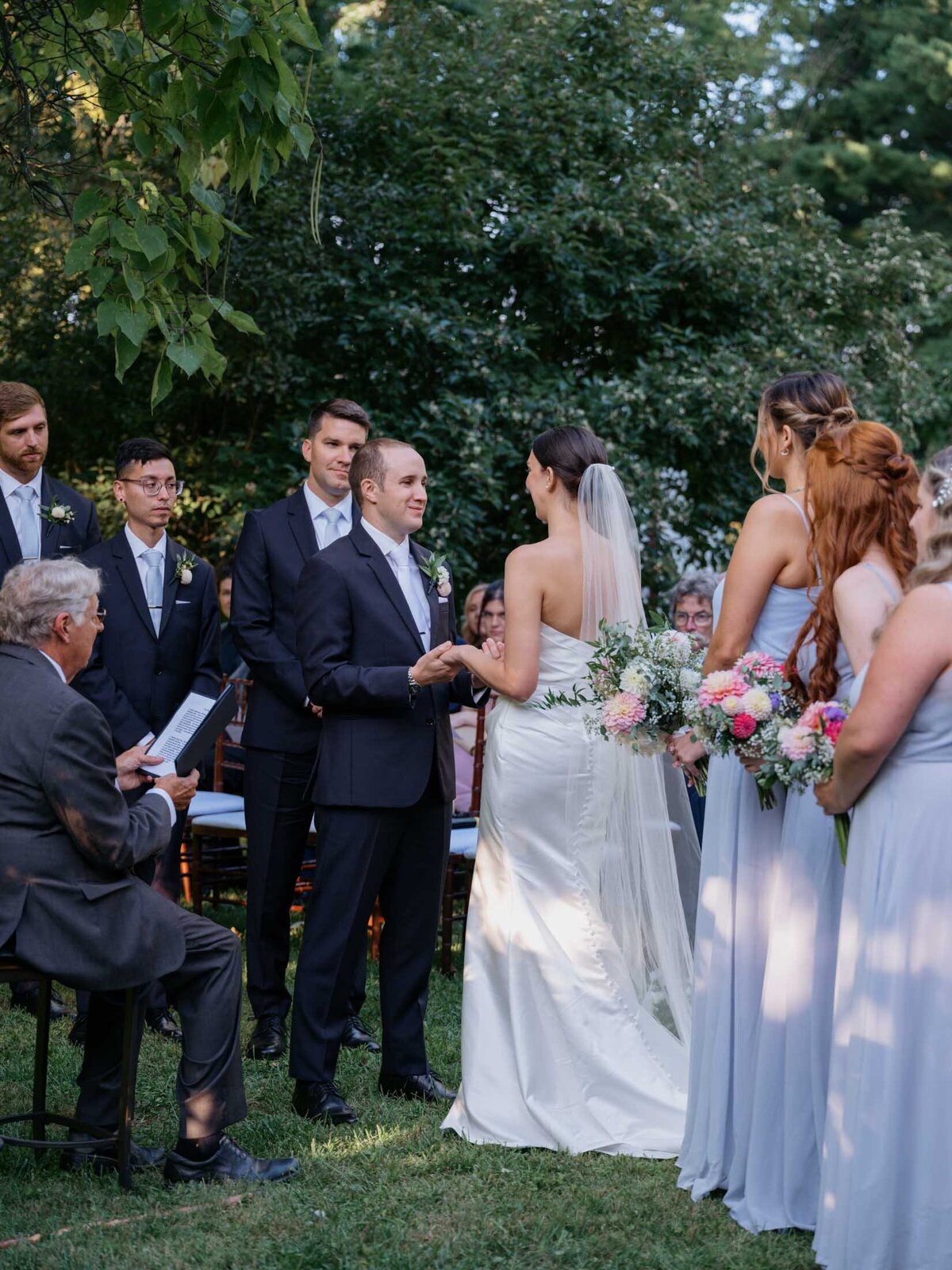 Outdoor wedding ceremony under clear blue sky.