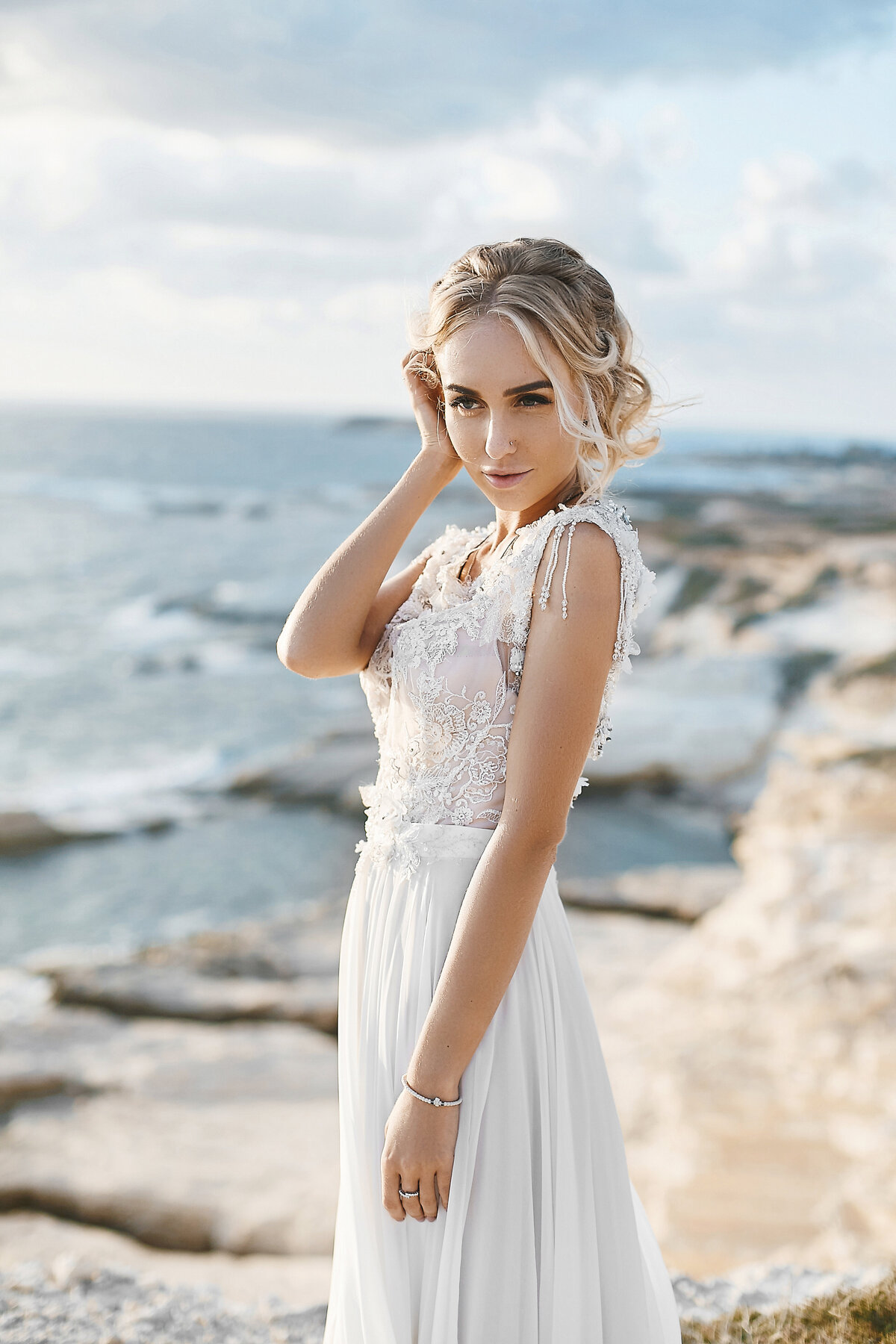 beautiful-young-blonde-model-woman-with-nude-makeup-fashionable-wedding-dress-walking-sea-coast-cyprus