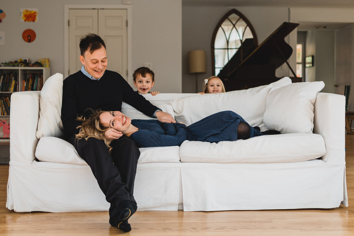 Family of four on couch in their living room