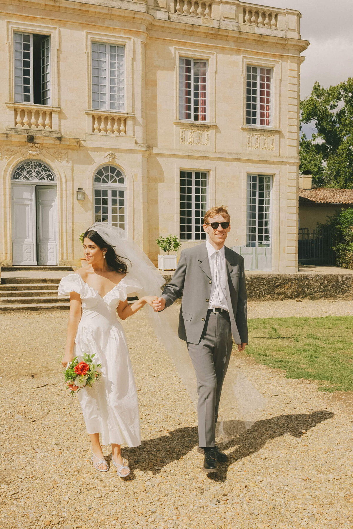 Bride and groom in front of French château captured by Wedding Photographer France