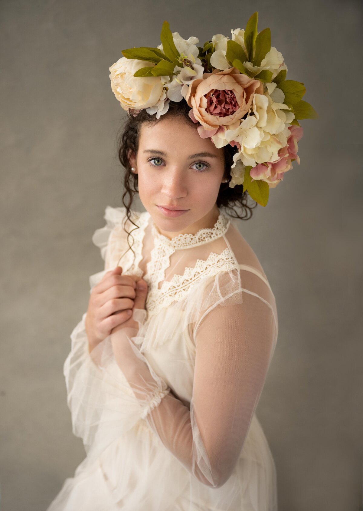 Young girl posing with flower head piece