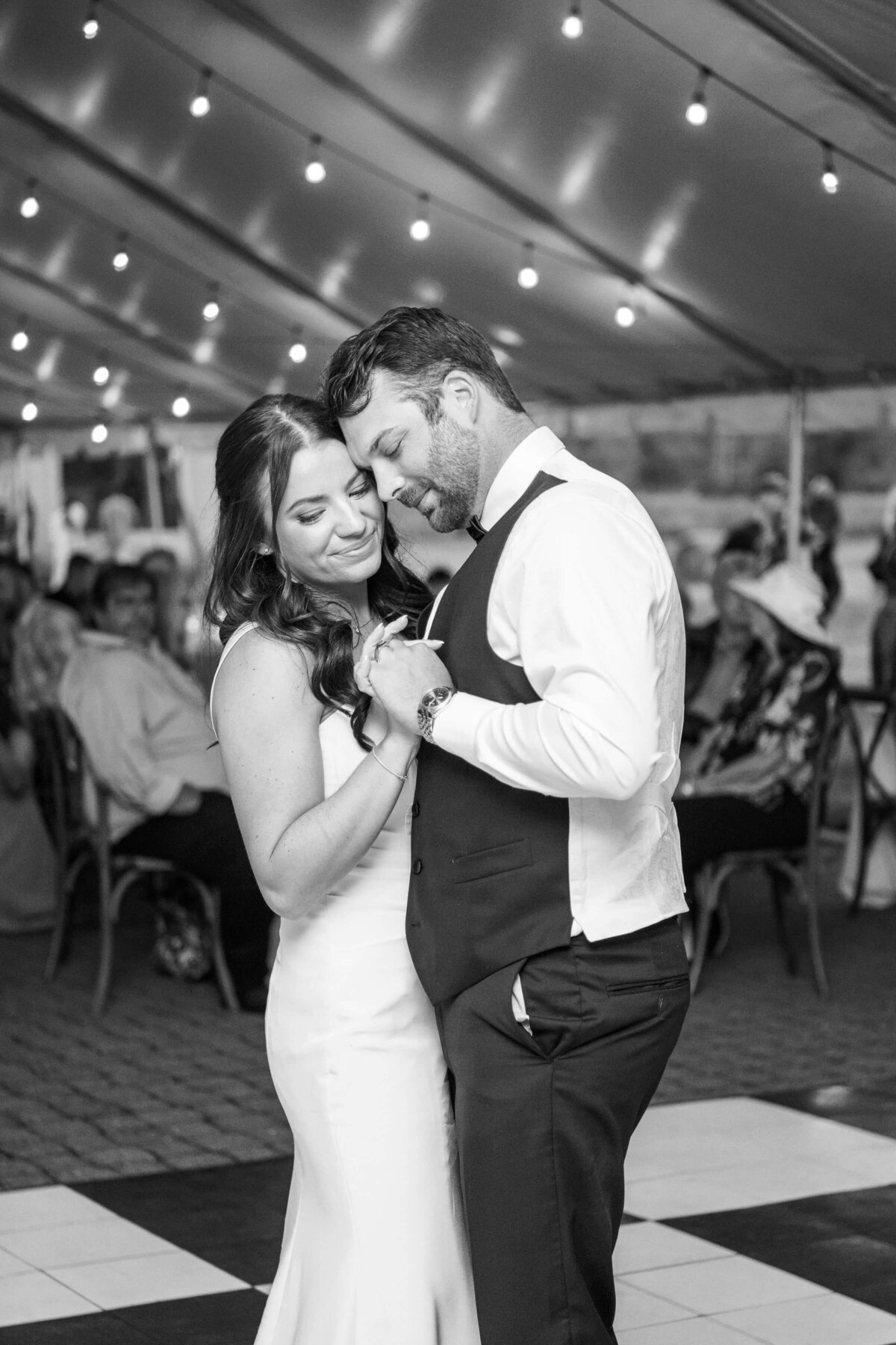A bride and groom have their first dance at their wedding reception.