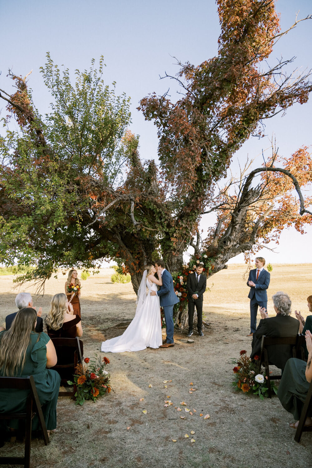 couple-sharing-first-kiss-under-old-oak-tree