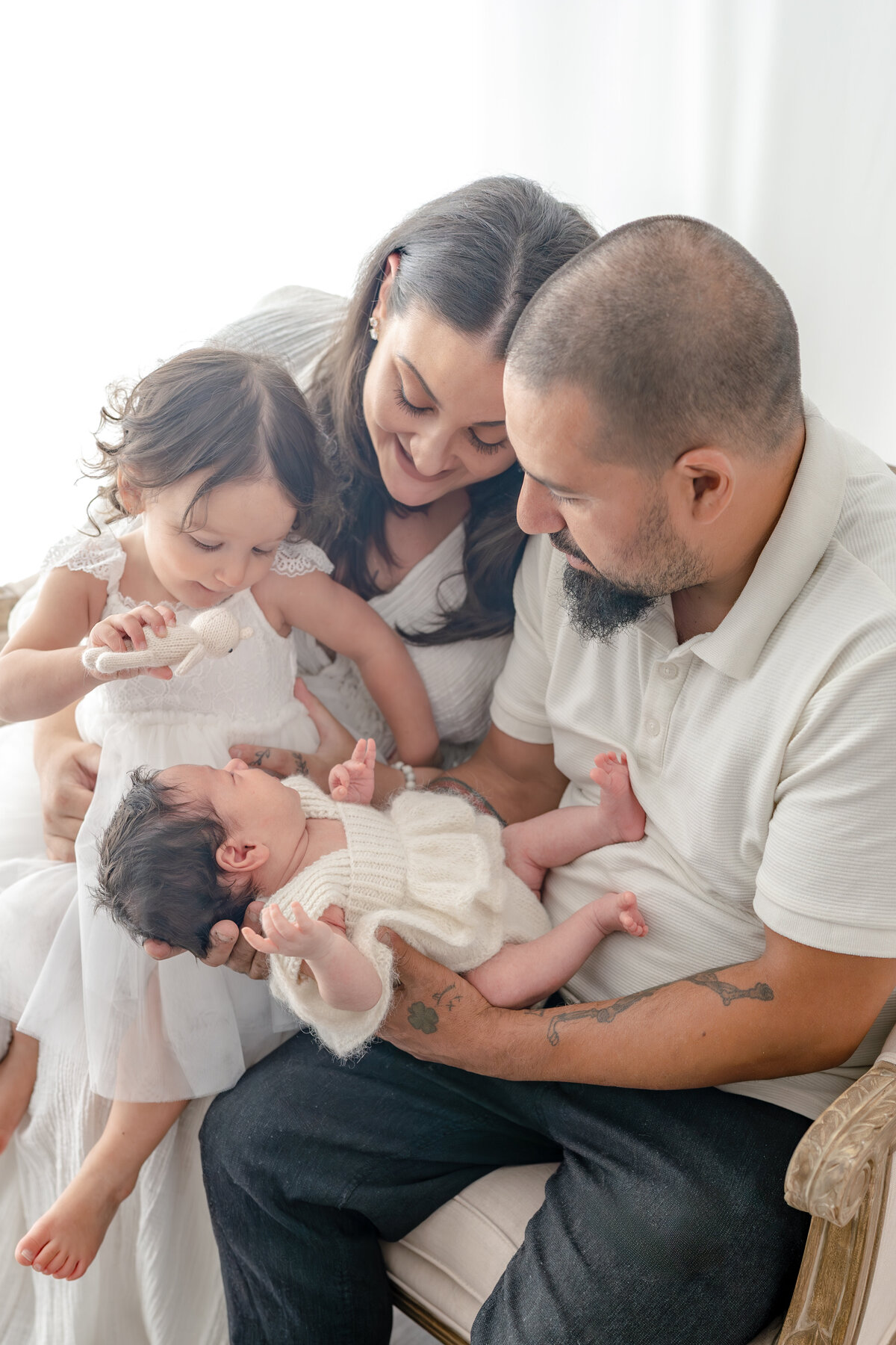Family holding baby during natural light Barrie newborn photography session 