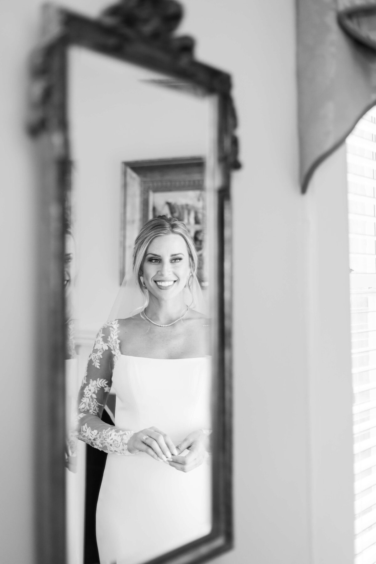 Bride looking in a mirror at her reflection