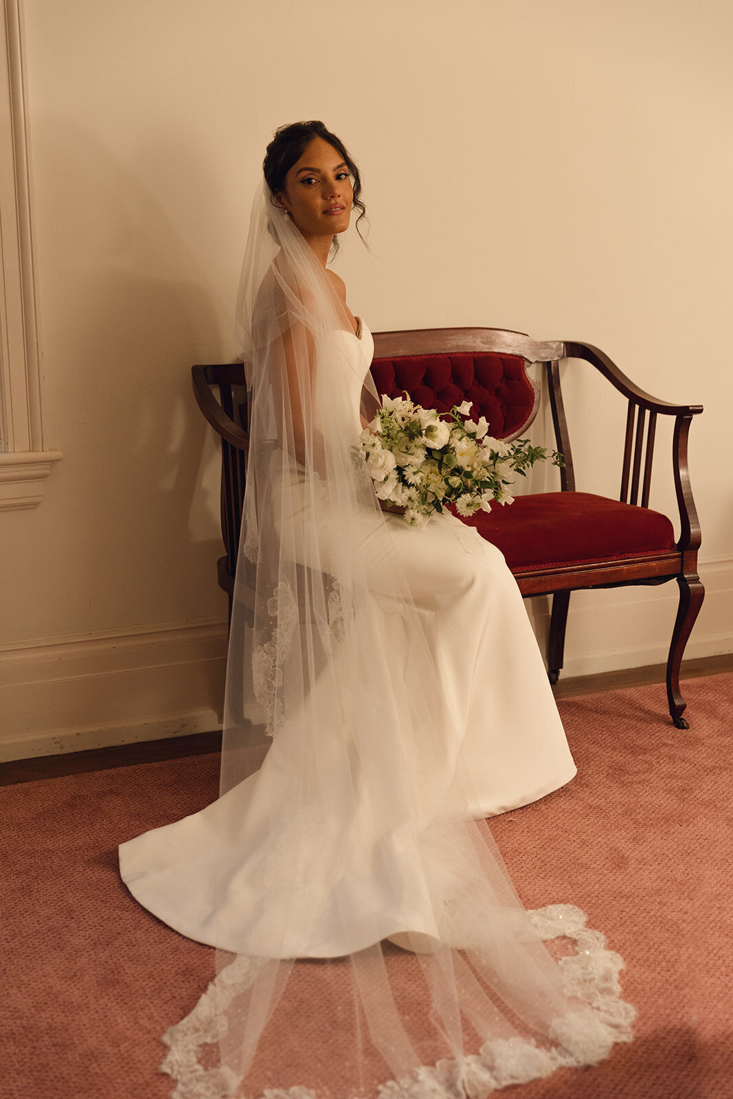 Bride posing in a wedding dress holding a bouquet