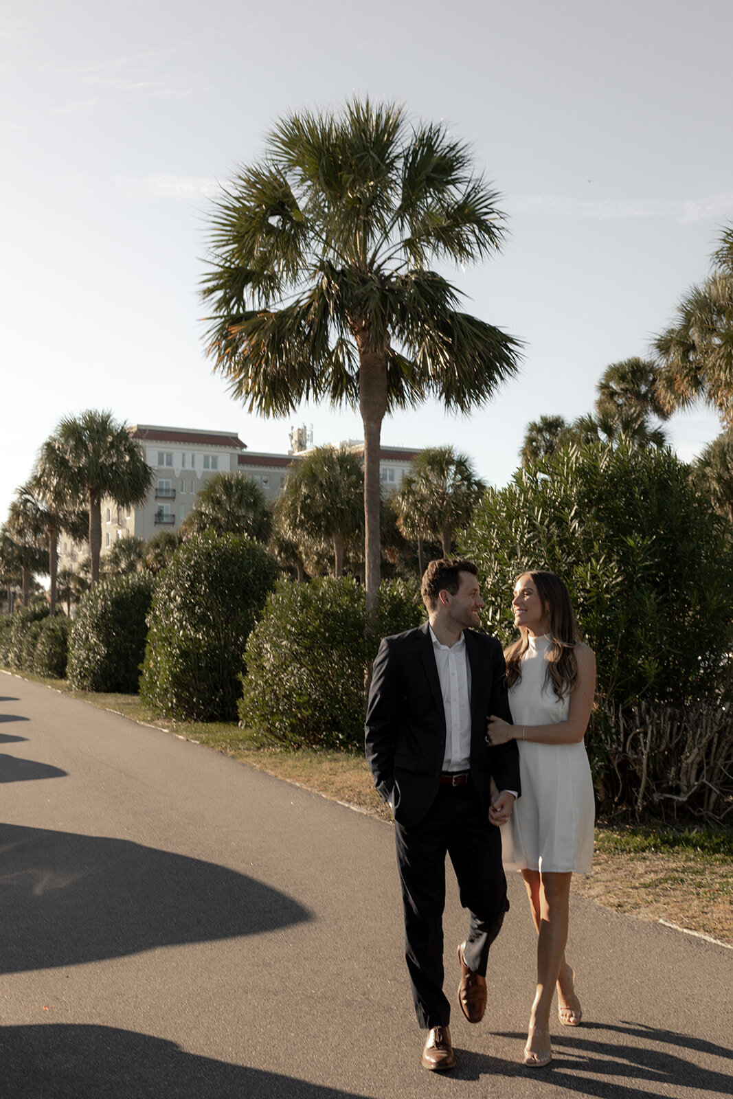 Couple walking along Charleston Battery. Charleston Engagement Photo session