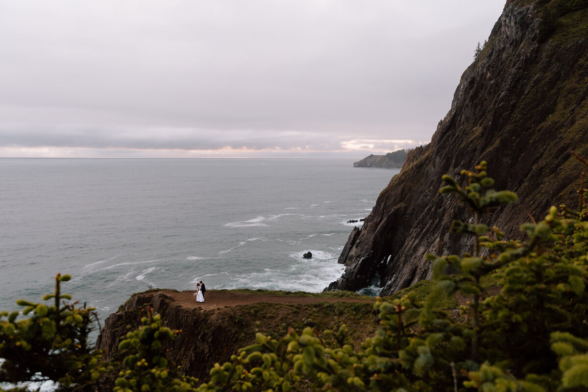 Couple on a cliff edge on the Oregon Coast.