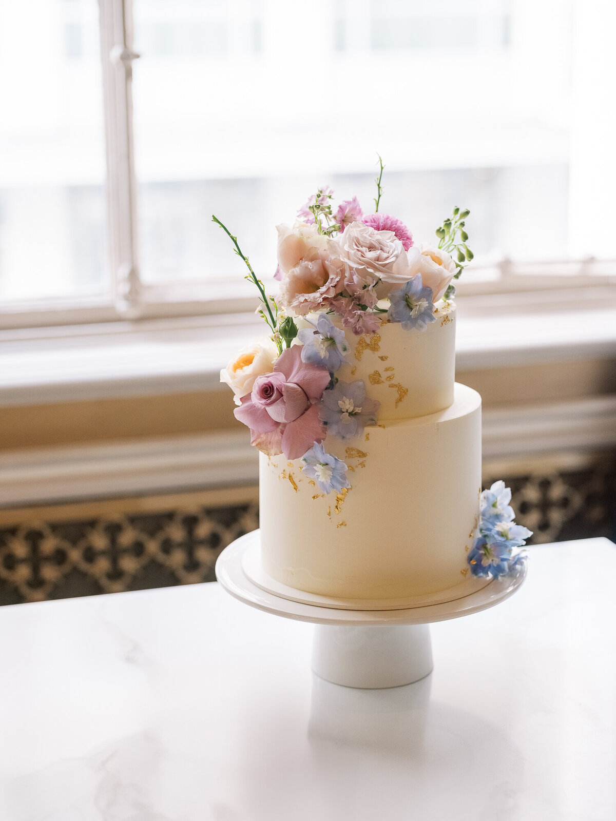 Pastel florals with wedding cake at Beacon Grand wedding
