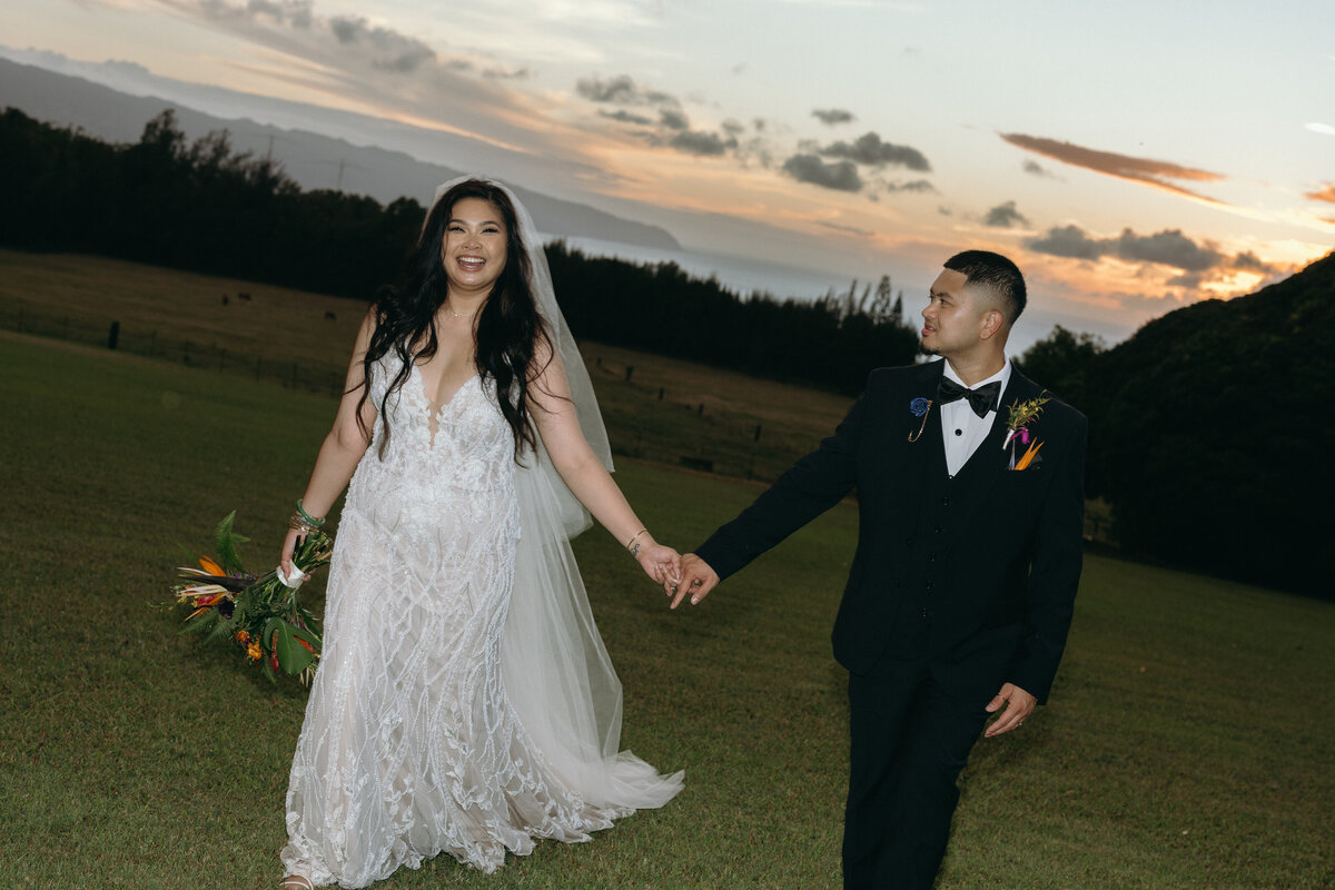 Luxury wedding couple at five-star Hawaiian resort, bride in strapless satin gown and long veil