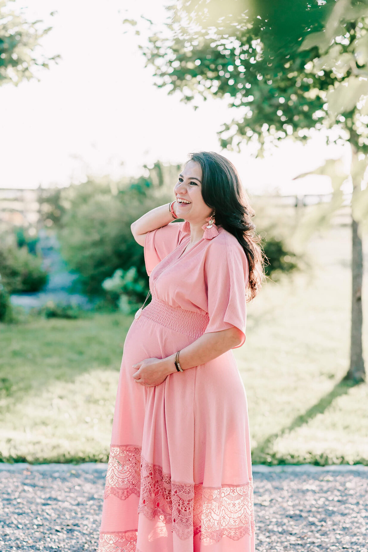 An expecting mother laughing joyfully at her northern virginia maternity session