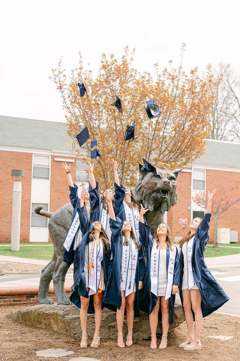 Quinnipiac students graduation cap toss