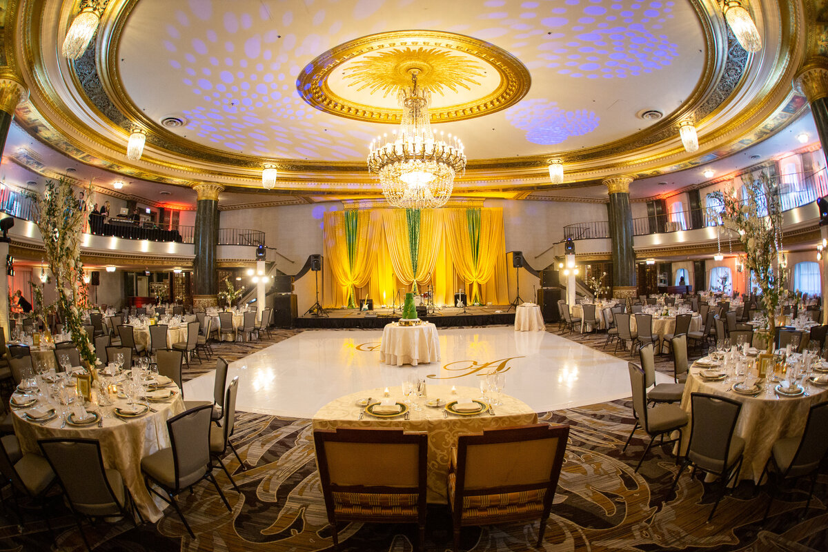 A wedding reception featuring colorful decor, white vinyl dance floor with monogram at the Intercontinental Hotel in Chicago, IL
