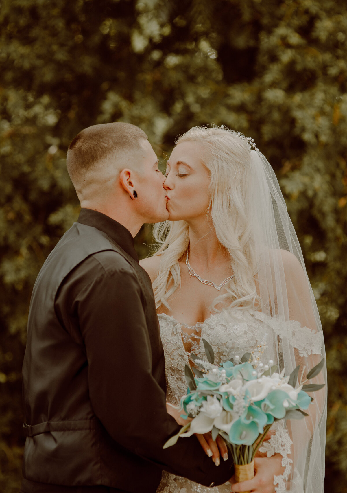 couple kissing during wedding day