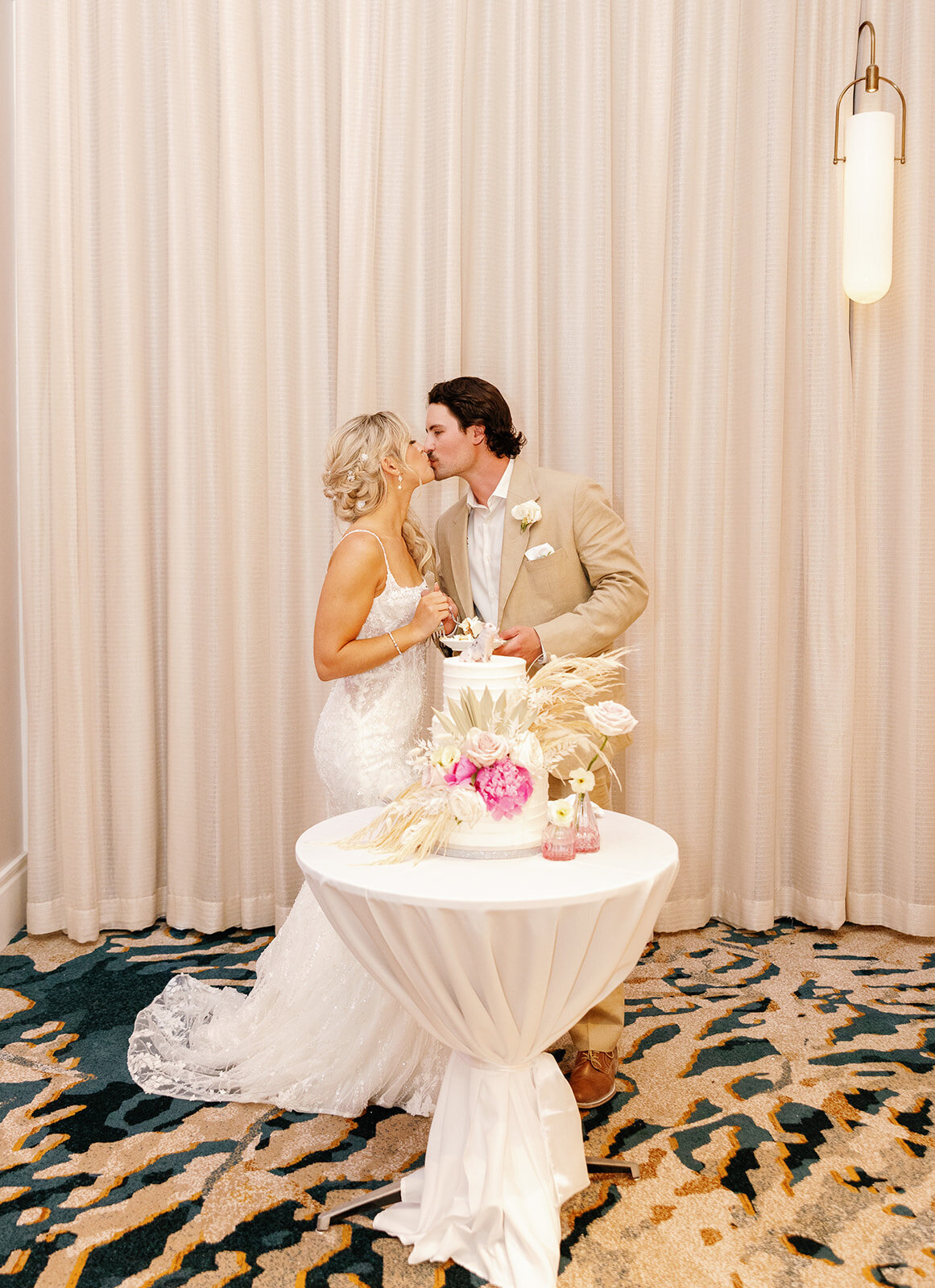 Brenda & Stephen share a romantic kiss during their cake-cutting ceremony at Cheeca Lodge. Claudia Amalia Wedding Photography.