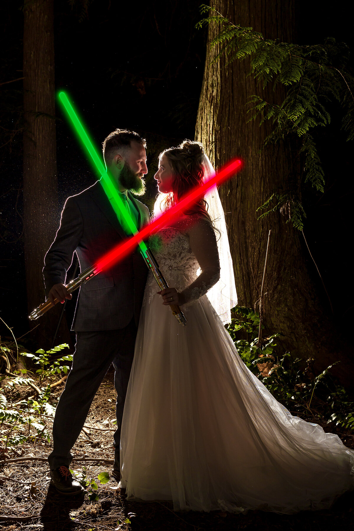 Bride and groom cross their lightsabres at their Star Wars wedding